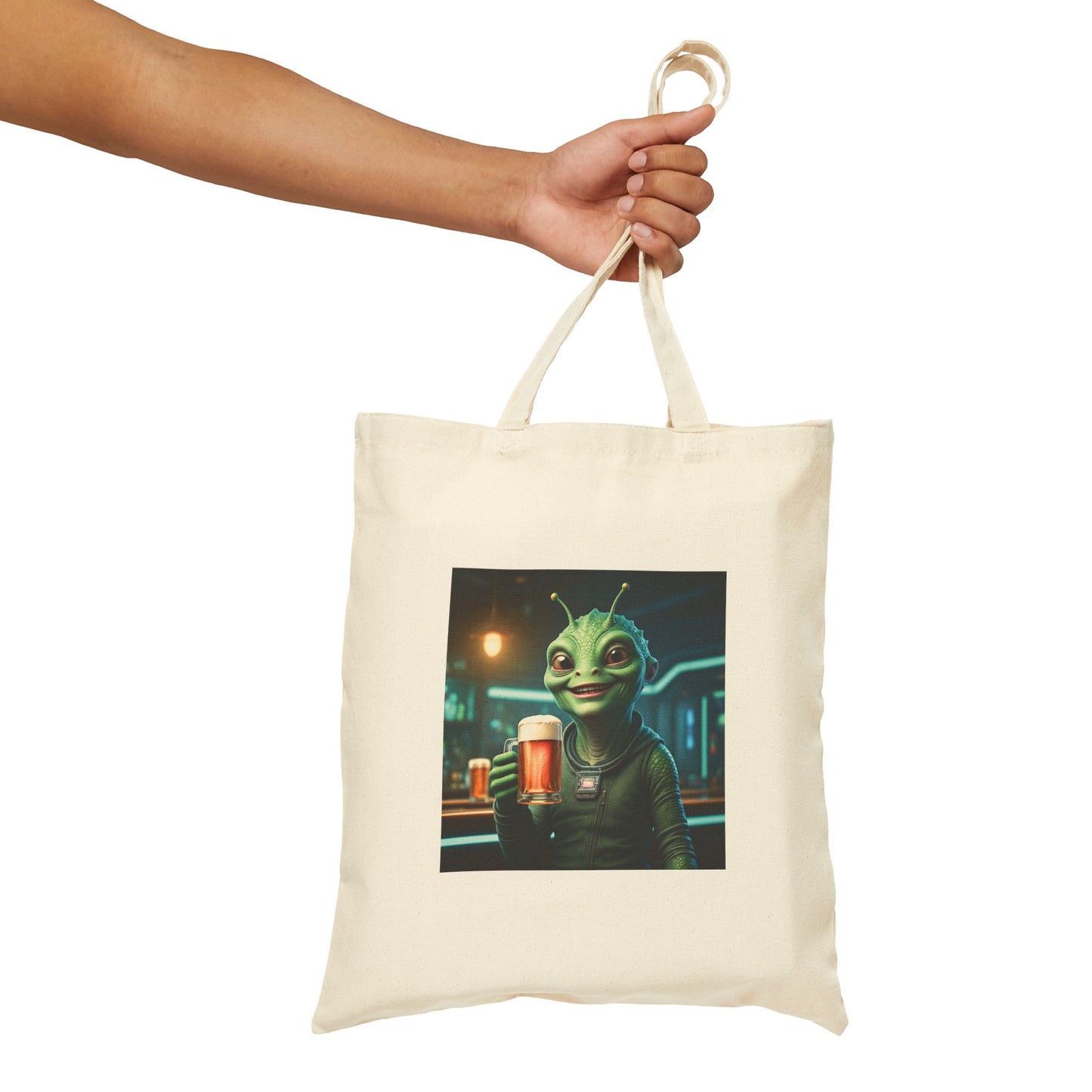 Alien woman drinking a Beer in a pub at night. The alien Is featured on a Natural color Canvas tote bag.