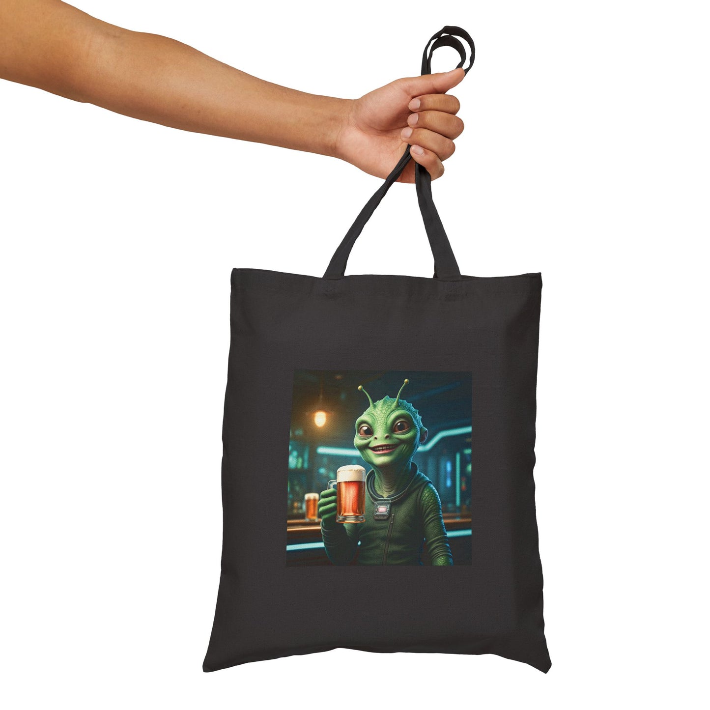 Alien woman drinking a Beer in a pub at night. The alien Is featured on a black color Canvas tote bag.