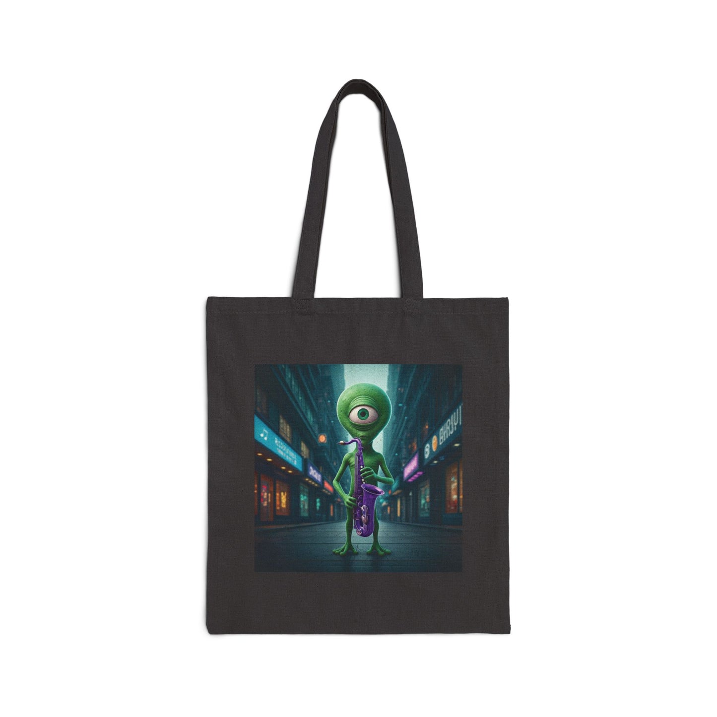 Alien playing sax in a empty city at Night. The alien Is featured on a black color Canvas tote bag.