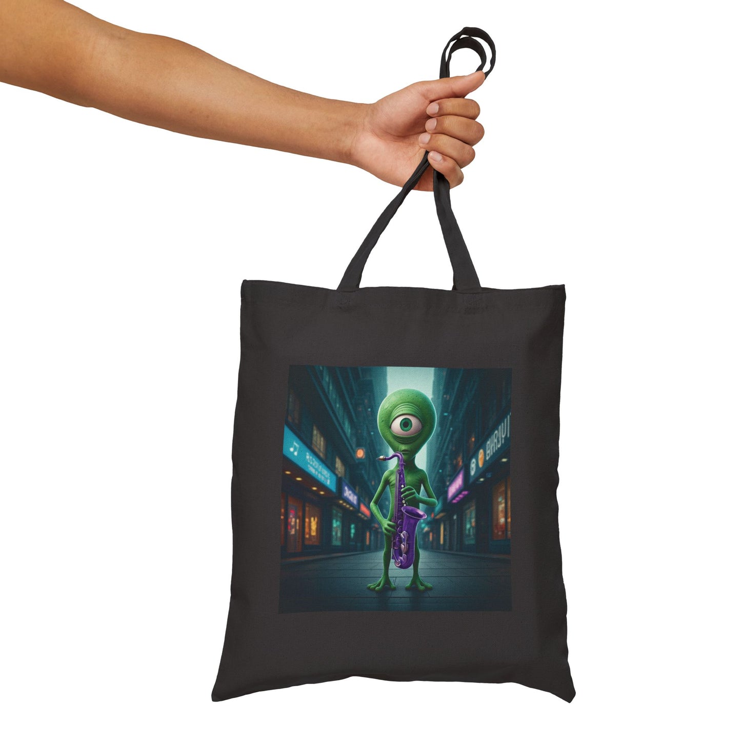 Alien playing sax in a empty city at Night. The alien Is featured on a Natural color Canvas tote bag.