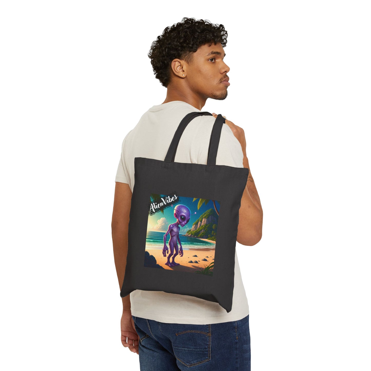 Alien at Beach natural color tote bag: a funny alien walking on a sandy beach. Bag on man shoulder.