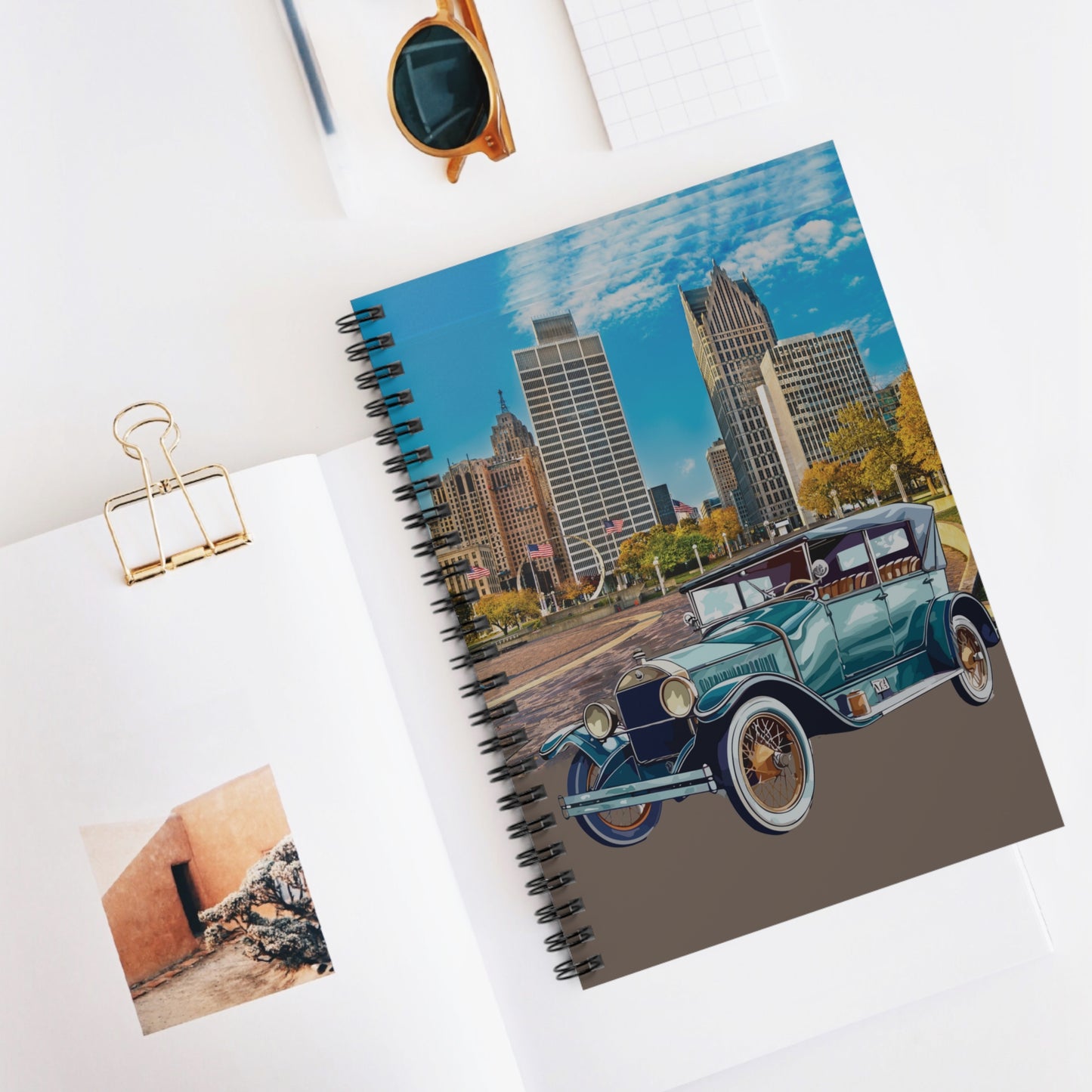 Notebook with a cityscape and vintage Buick car design