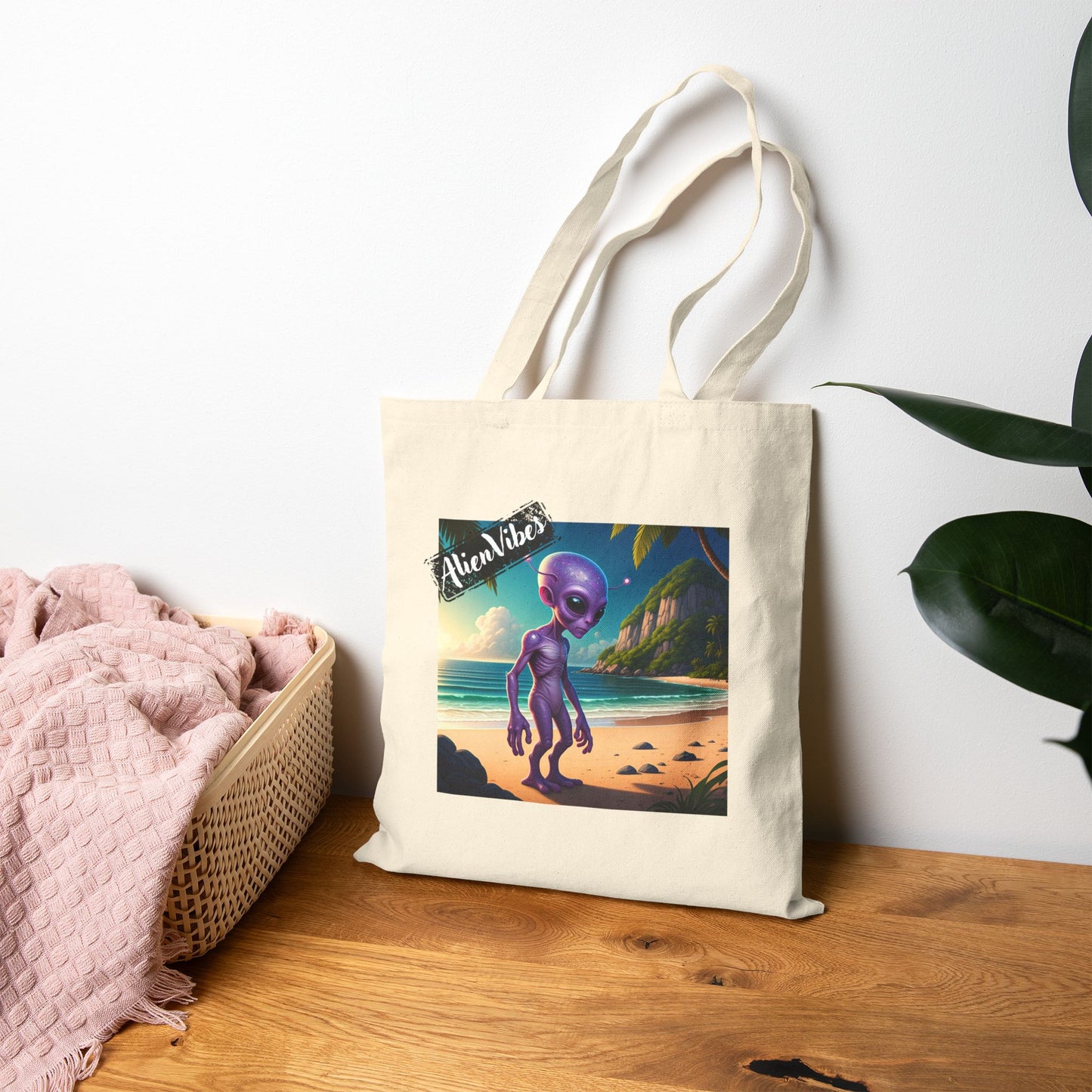 Alien at Beach natural color tote bag: a funny alien walking on a sandy beach. Bag leaning against the wall