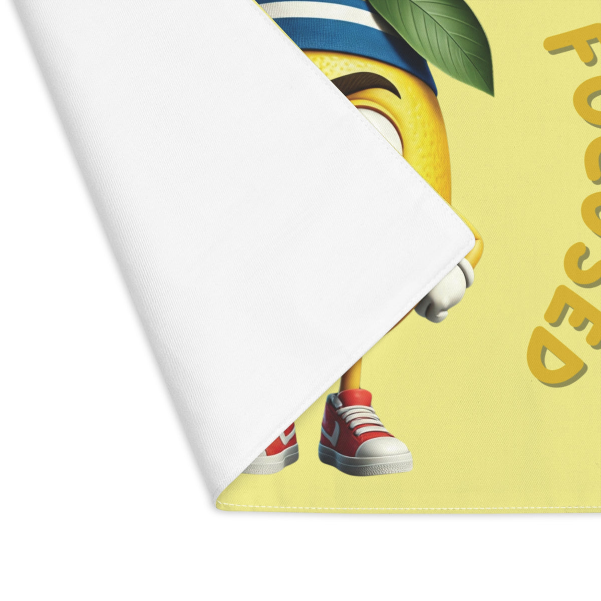 Close-up view of the folded corner showing the clean white backside and durable stitched edge of a washable dining table placemat.