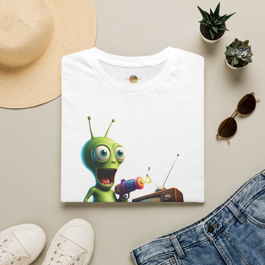 Folded white Alien TV Zapping retro sci-fi graphic t-shirt featuring a green alien channel-surfing a vintage TV, styled with blue jeans, sneakers, and a straw hat.