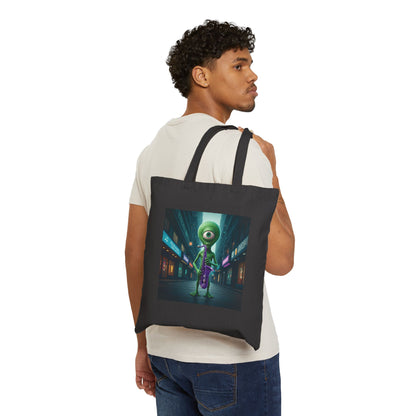 Alien playing sax in a empty city at Night. The alien Is featured on a black color Canvas tote bag on a young man shoulder.