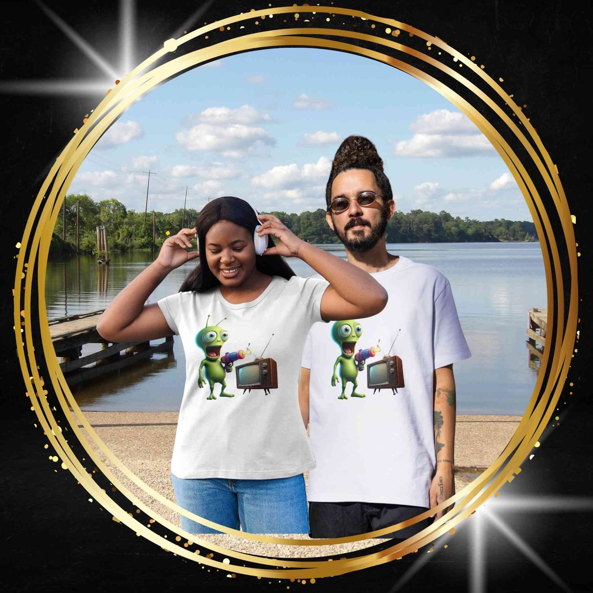 Two people by a lake wearing white unisex t-shirts with an alien doing tv.