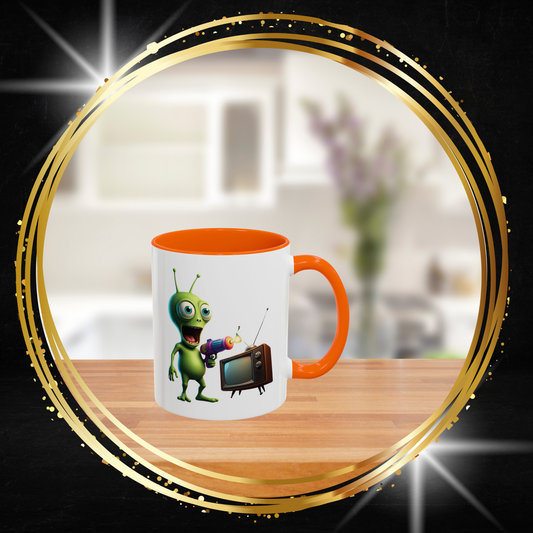 Orange accent coffee cup showing a retro alien watching a vintage TV, nostalgic sci-fi aesthetic home decor.