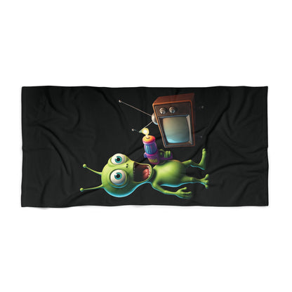 Black premium beach towel with a colorful 3D alien holding a retro TV remote, unique and original design.