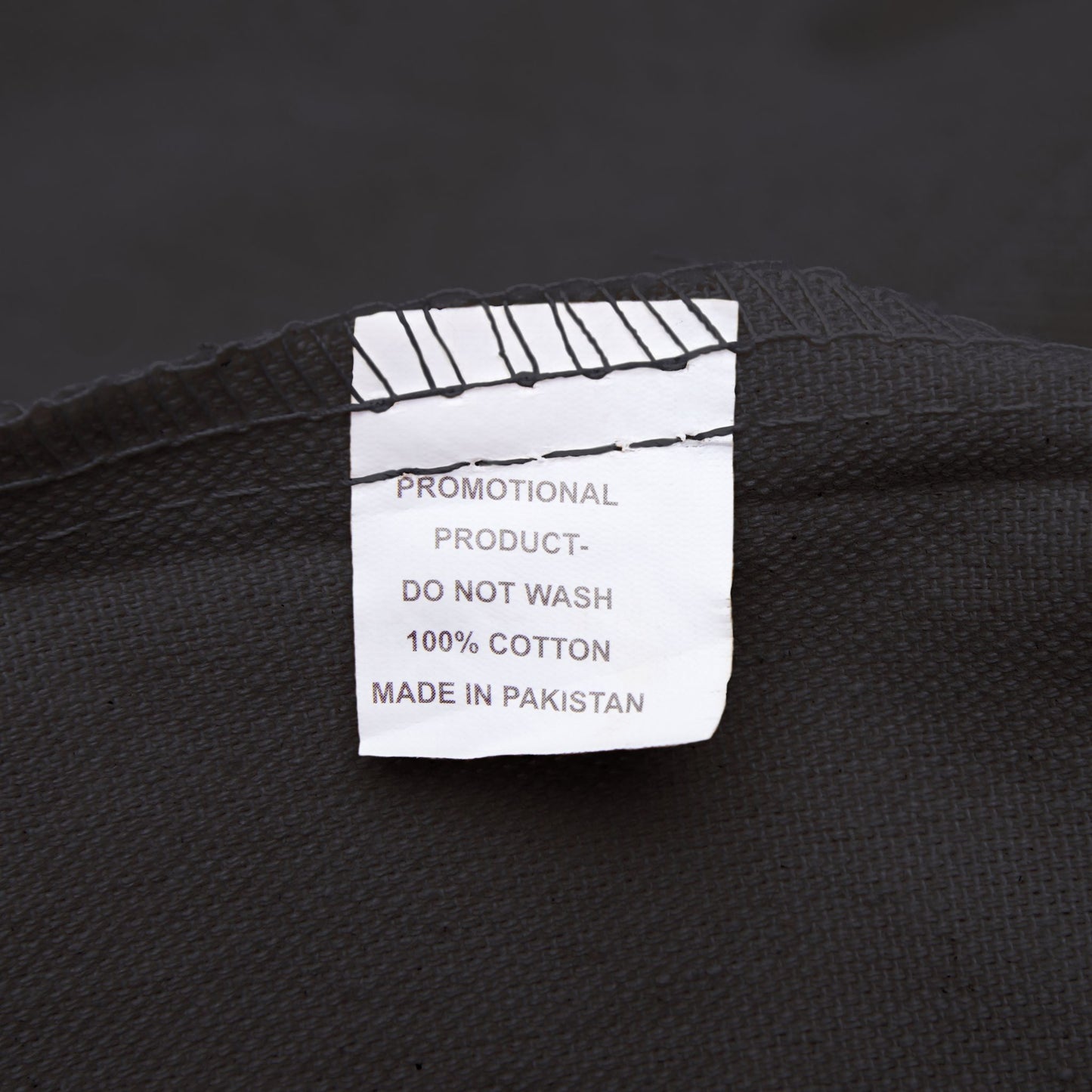 Clothing label on a black fabric background