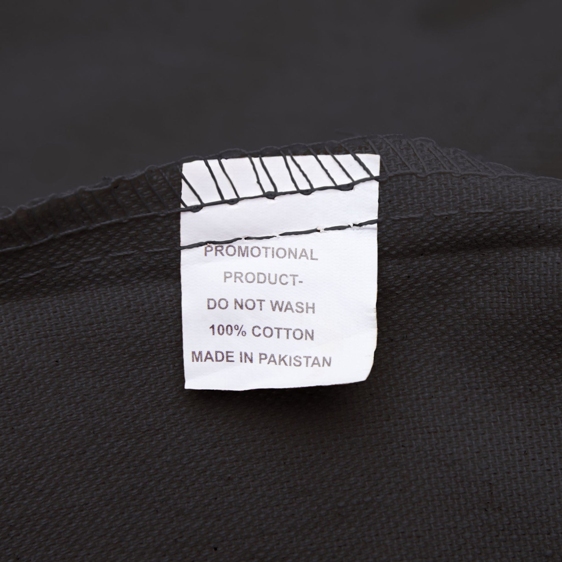 Clothing label on a black fabric background