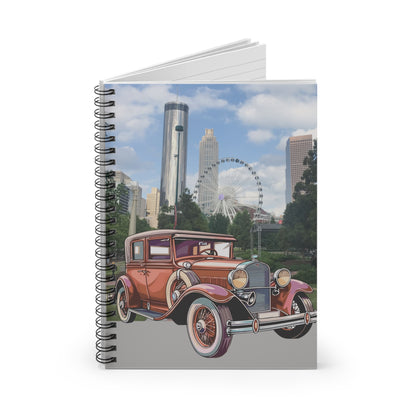Notebook with a vintage car design on the cover against a cityscape background