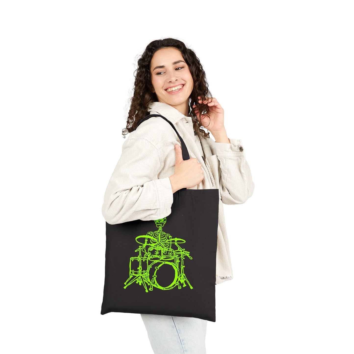 Woman holding a black tote bag with a unique green drum set design design