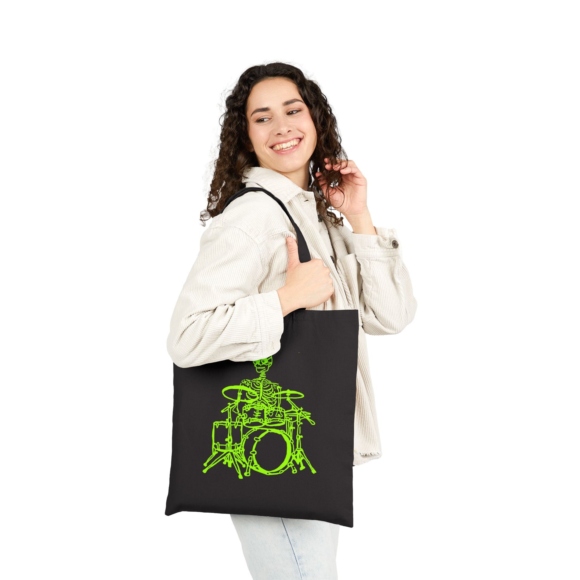 Woman holding a black tote bag with a unique green drum set design design