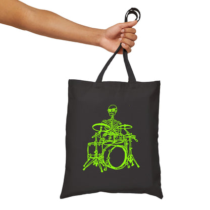 Black tote bag with green skeleton playing drums design held by hand