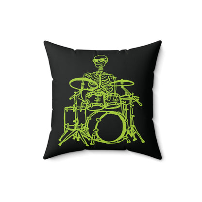 Fluorescent green skeleton playing a drum kit on a white throw pillow.