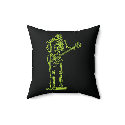 Fluo green skeleton performing with a guitar and microphone on a pillow.