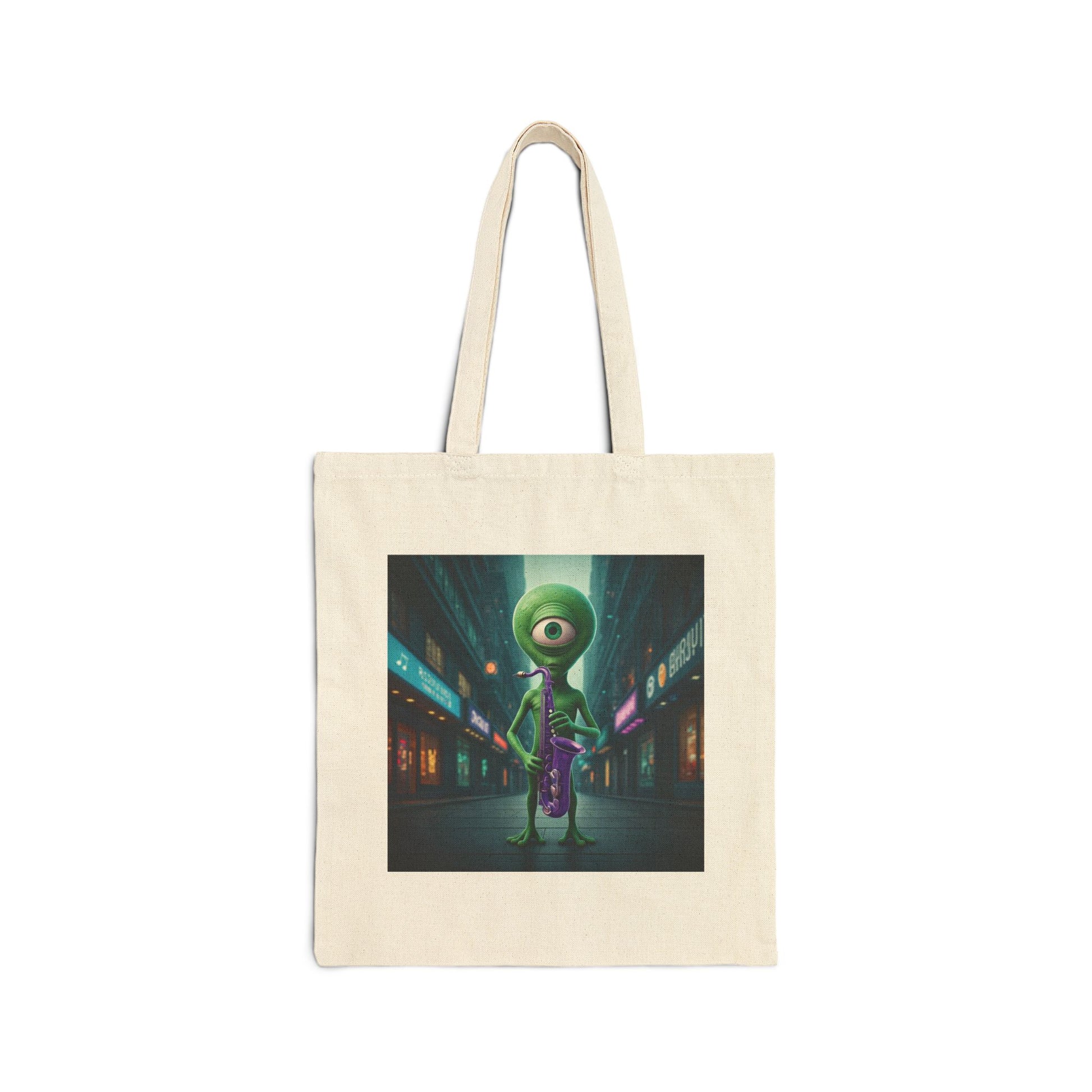 Alien playing sax in a empty city at Night. The alien Is featured on a Natural color Canvas tote bag.