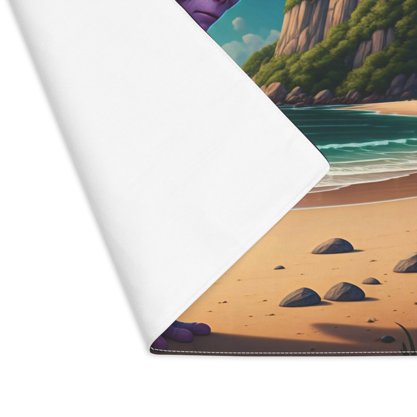 Close-up of a beach scene with rocks and ocean waves on a white surface.