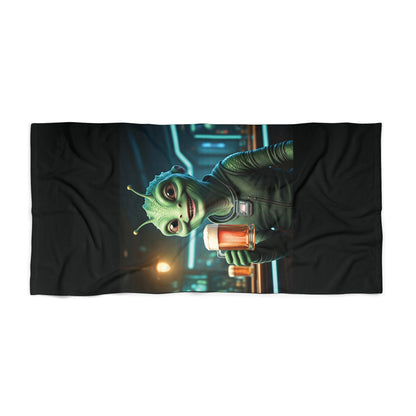 Flat lay view of a high-quality black beach towel with a vibrant alien drinking at a futuristic neon bar design