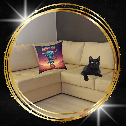 Decorative throw pillow featuring an alien playing American football graphic from From Space Store on a beige sofa next to a black cat.