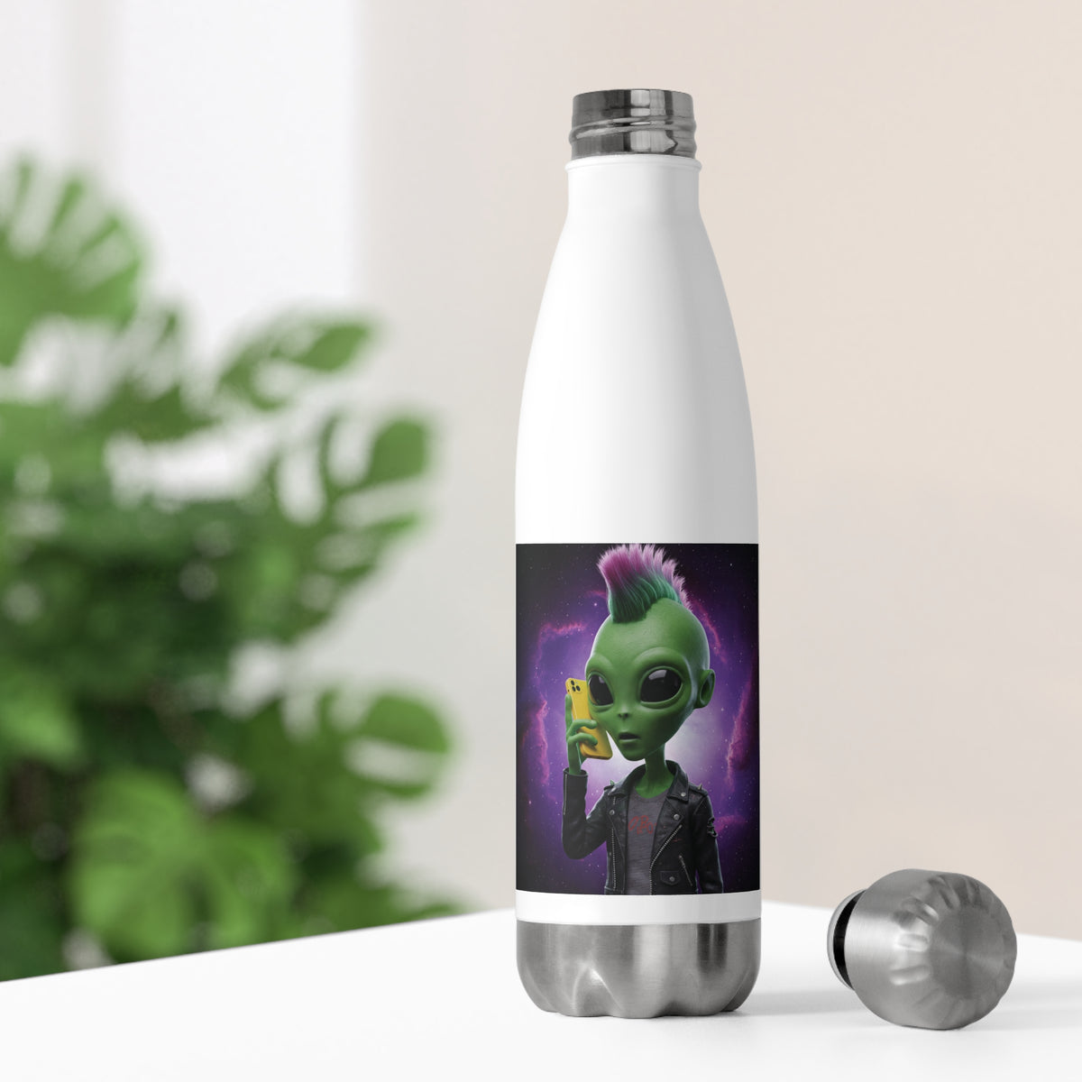 White thermal travel water bottle resting on a bright desk with its stainless steel cap off, showing a cyberpunk alien punk design for home office hydration.