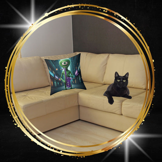 Decorative throw pillow featuring an alien playing a saxophone graphic from From Space Store on a beige sofa next to a black cat.