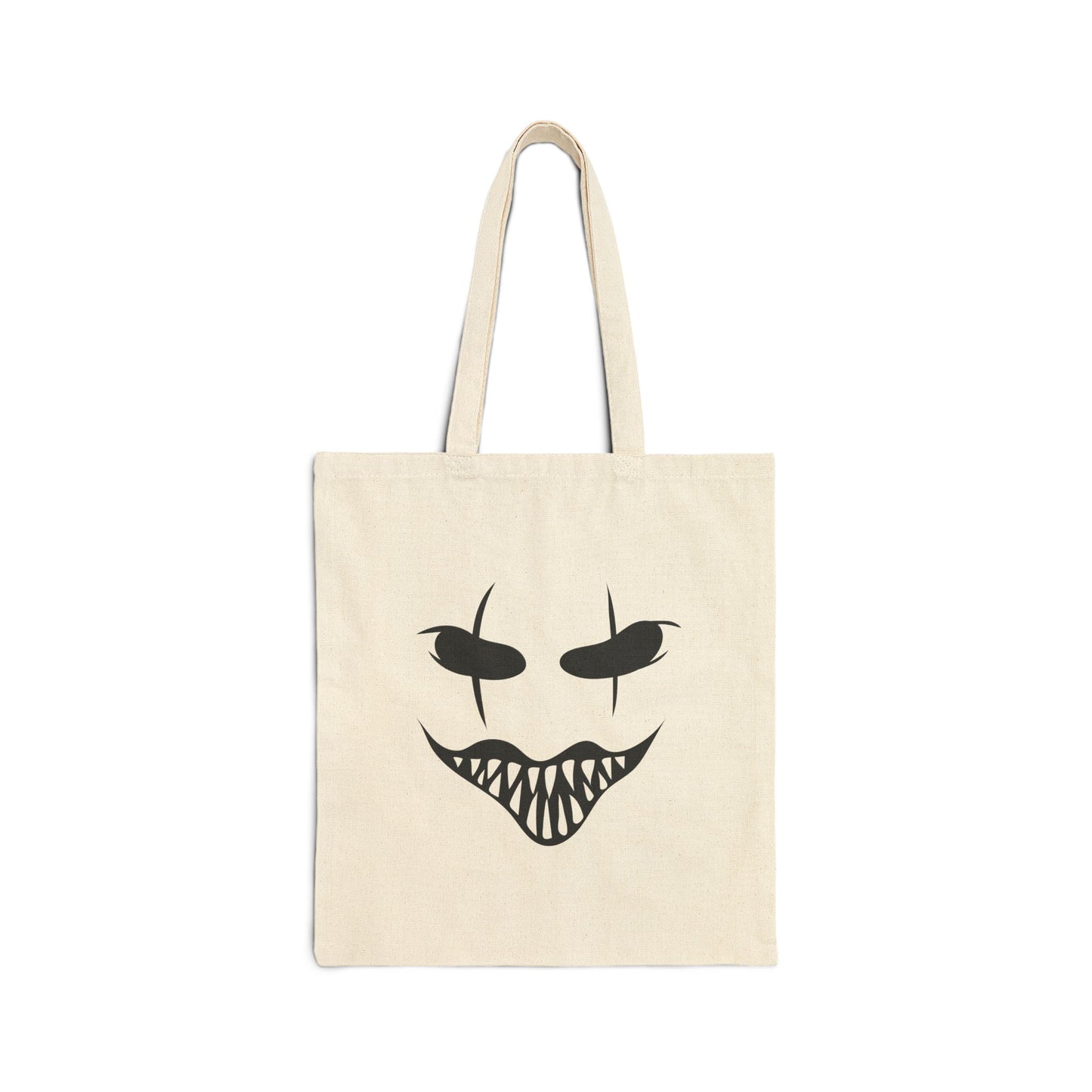 Beige tote bag with a black face design on a white background
