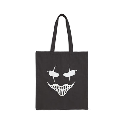 Black tote bag with a white graphic of a face on a white background
