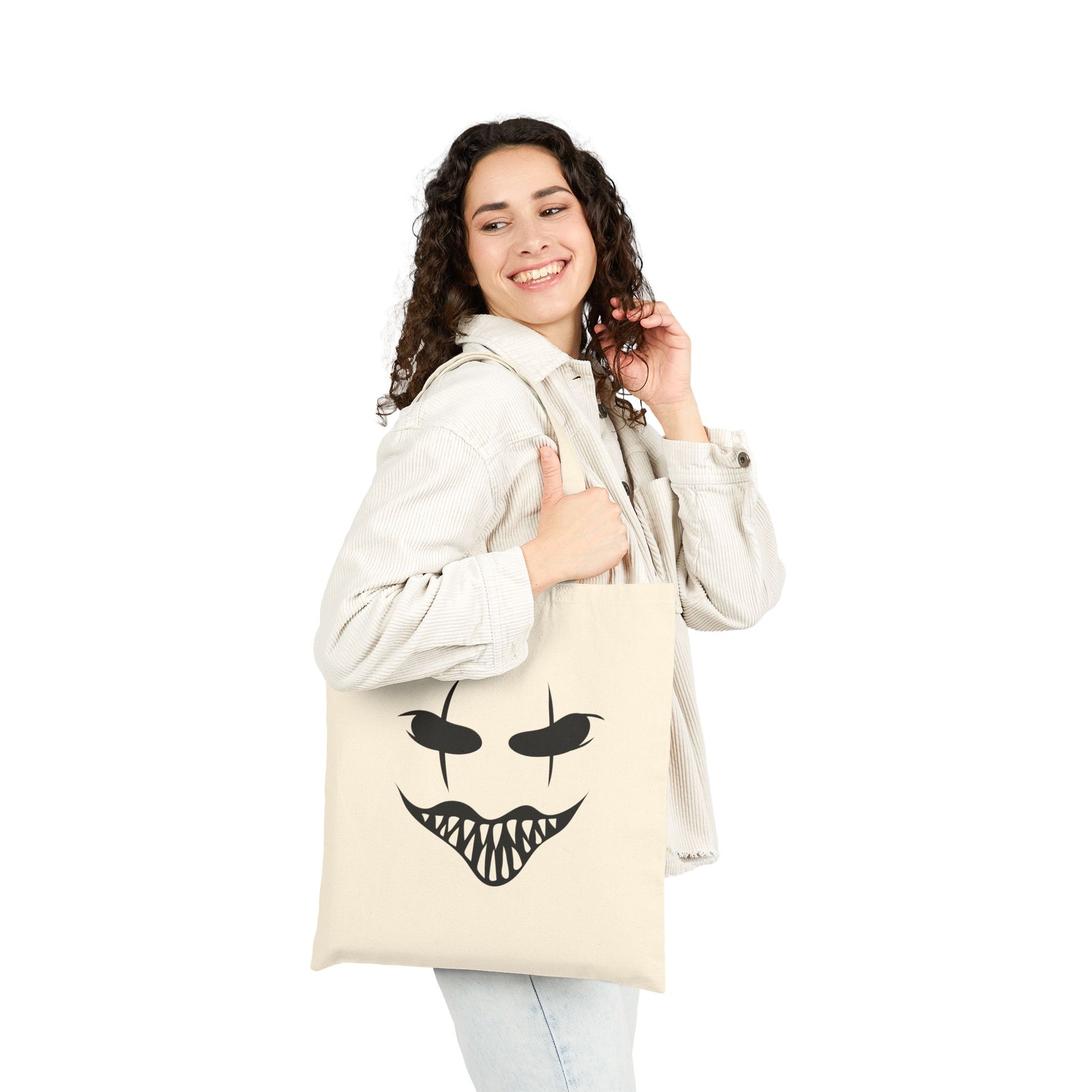 Woman holding a halloween Mask tote bag