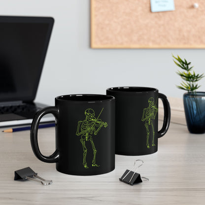 Two black mugs with skeleton designs on a desk with office items.