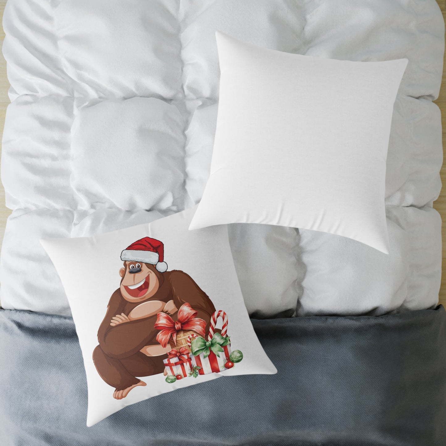 Decorative pillow with a cartoon monkey wearing a Santa hat on a bed.