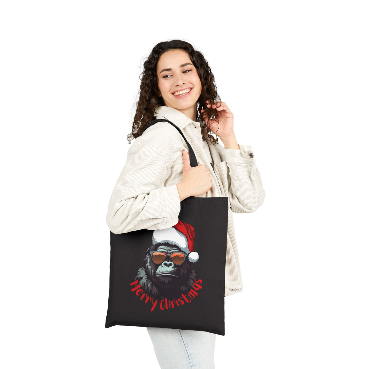 Woman wearing white jacket carrying a black cool gorilla christmas tote bag for funny holiday gift shopping