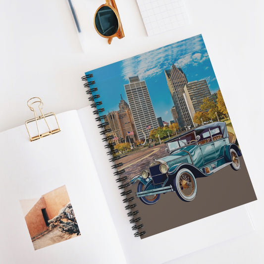 Notebook with a cityscape and vintage Buick car design 