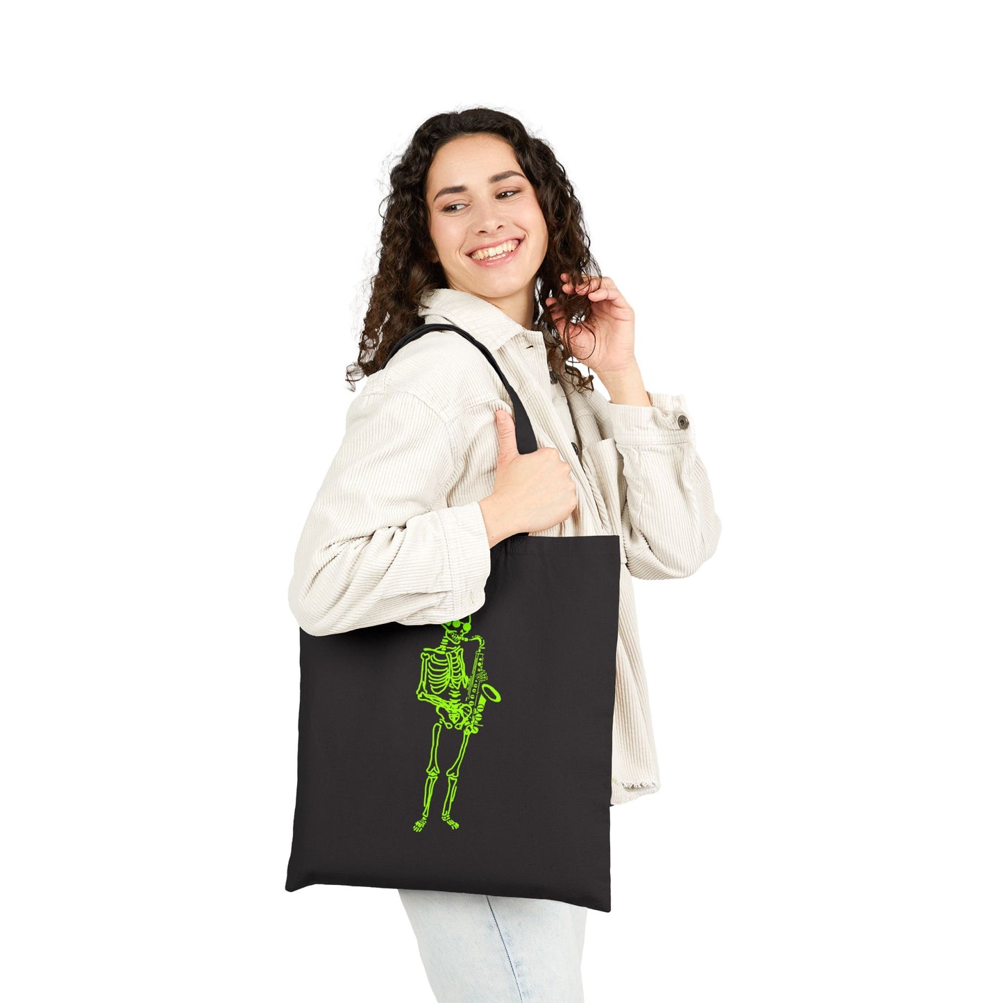 Woman holding a black tote bag with a green fluo saxophoinist skeleton design