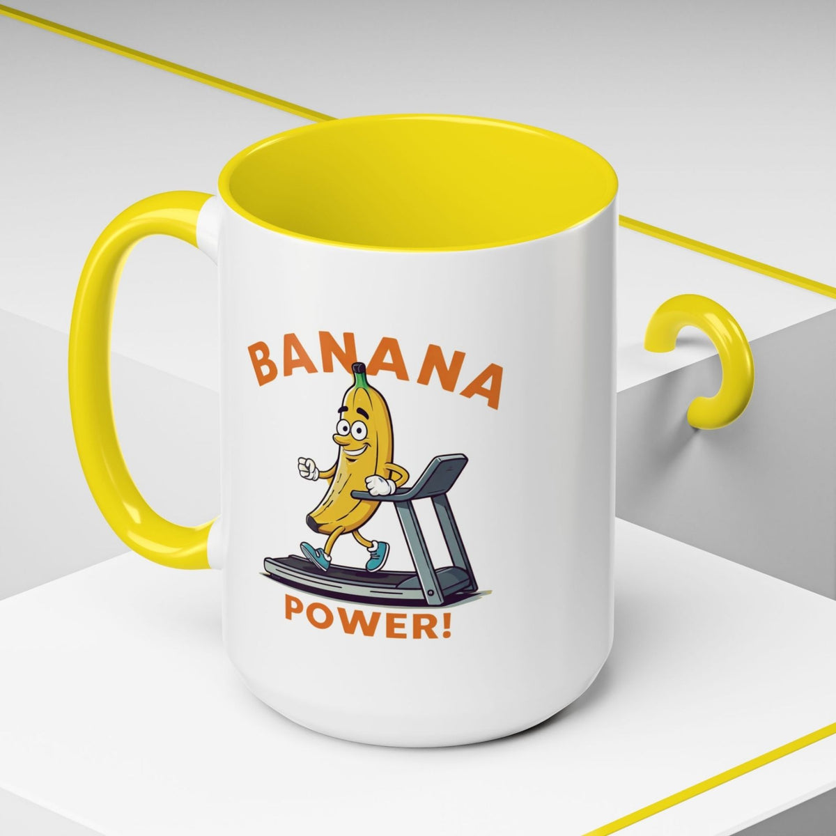 Yellow accent ceramic mug featuring a funny cartoon banana running on a treadmill with Banana Power text.