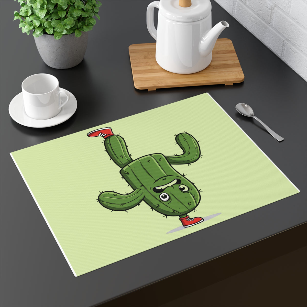 Decorative kitchen placemat with a funny breakdancing cactus graphic on a modern dining table.