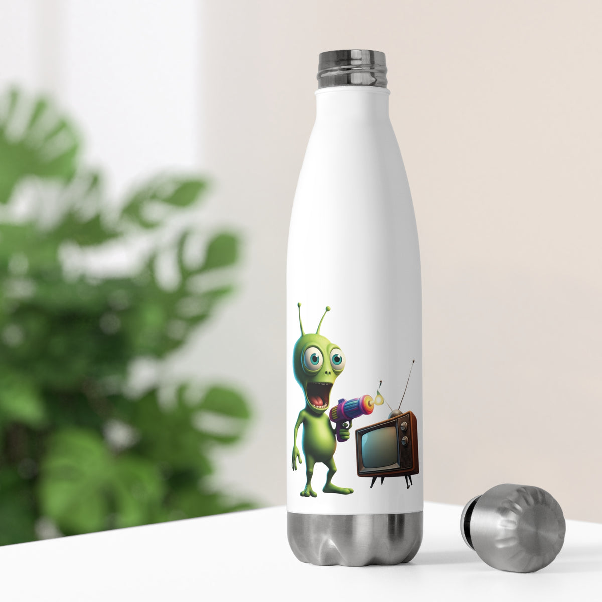 White thermal travel water bottle resting on a bright desk with its stainless steel cap off, showing a funny TV zapping alien design for pop culture geeks.