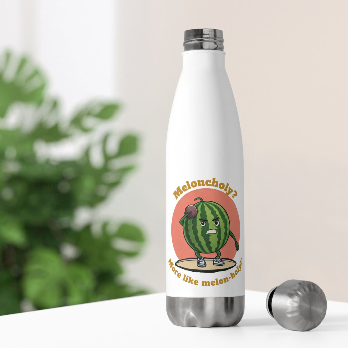 White thermal travel water bottle sitting on a bright desk with its stainless steel cap off, showing a funny fitness watermelon character illustration.