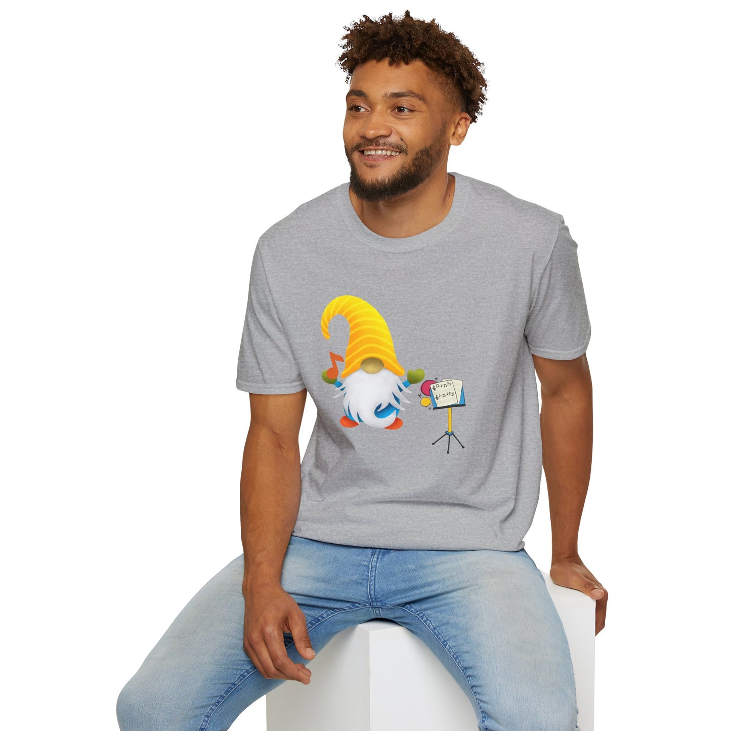 A man wearing a heather gray t-shirt with a colorful gnome graphic, the gnome behind a music stand up.