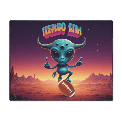 A blue three-eyed alien playing American football on a desert planet under a neon sign.
