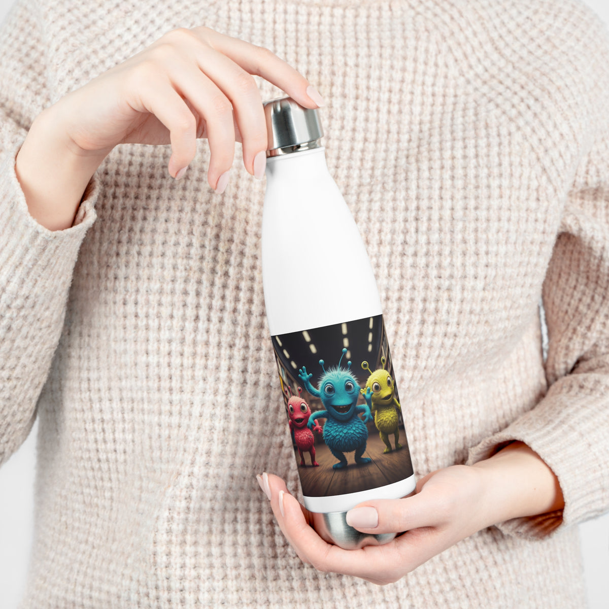 Close-up of hands opening the leak-proof screw cap of a white insulated travel water bottle with sci-fi cute alien squad artwork.