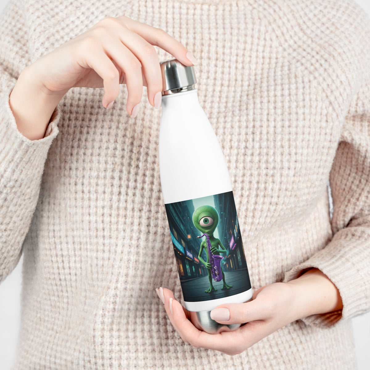 Close-up of hands opening the leak-proof screw cap of a white insulated travel water bottle with sci-fi jazz alien sax player artwork.
