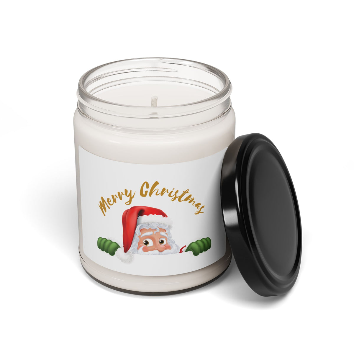 Clear glass jar scented Christmas candle showing a gold Merry Christmas text and peeking Santa design next to an open black metal screw-on lid.