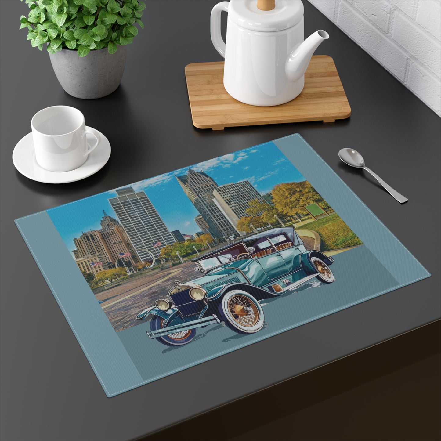Teal Buick Doctor Coupe parked with the Detroit skyline in the background on a cotton placemat.