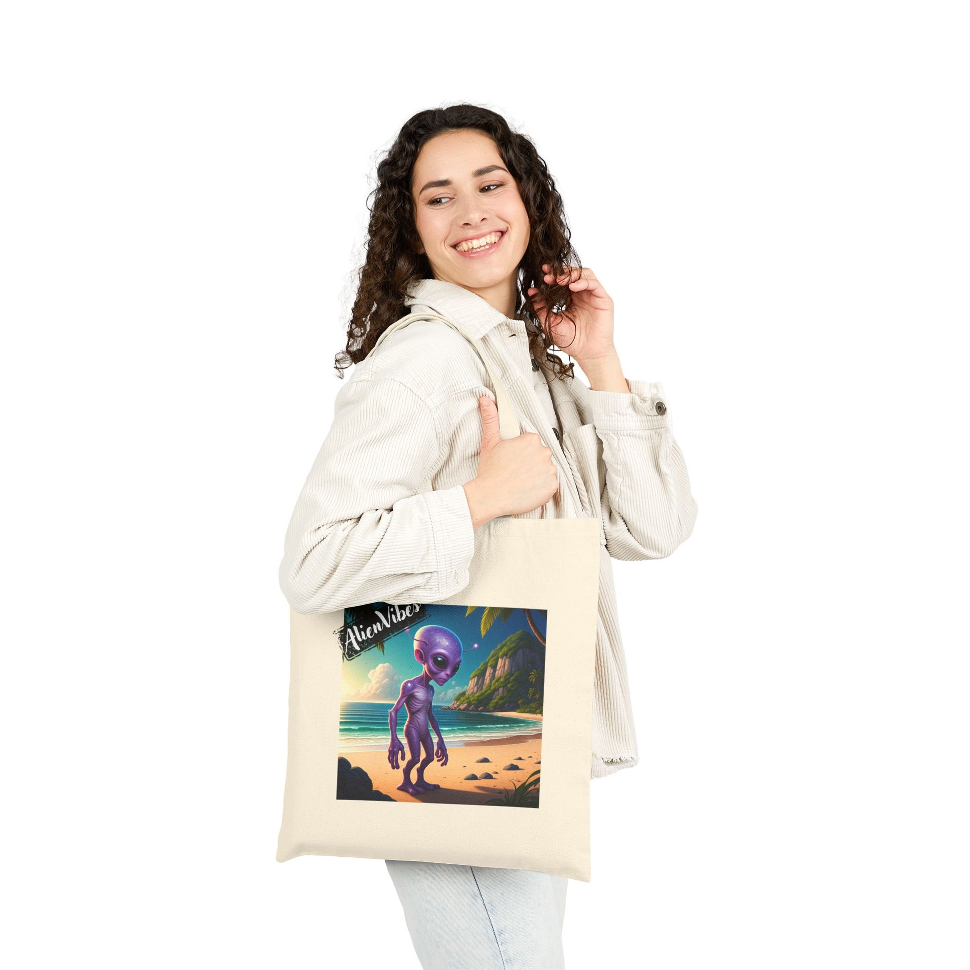 Alien at Beach natural color tote bag: a funny alien walking on a sandy beach. Bag on woman shoulder.