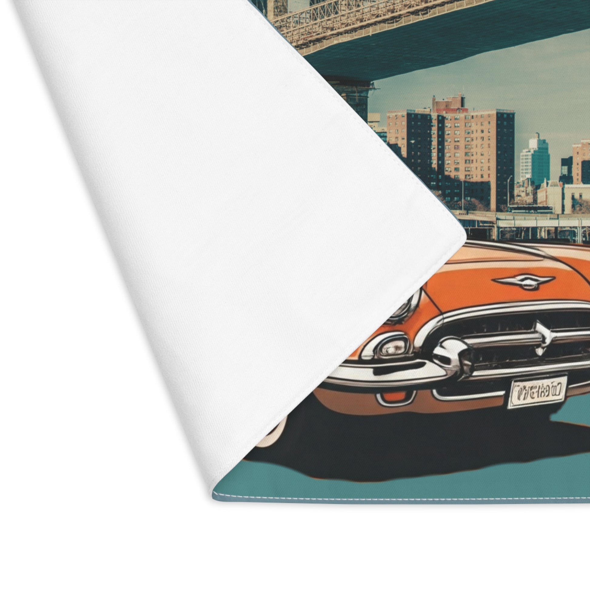 Roll of paper with a vintage car design on a cityscape background placemat