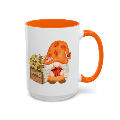 White and orange ceramic coffee mug with a colorful graphic of a mysterious gnome surrounded by autumn leaves and mushrooms.