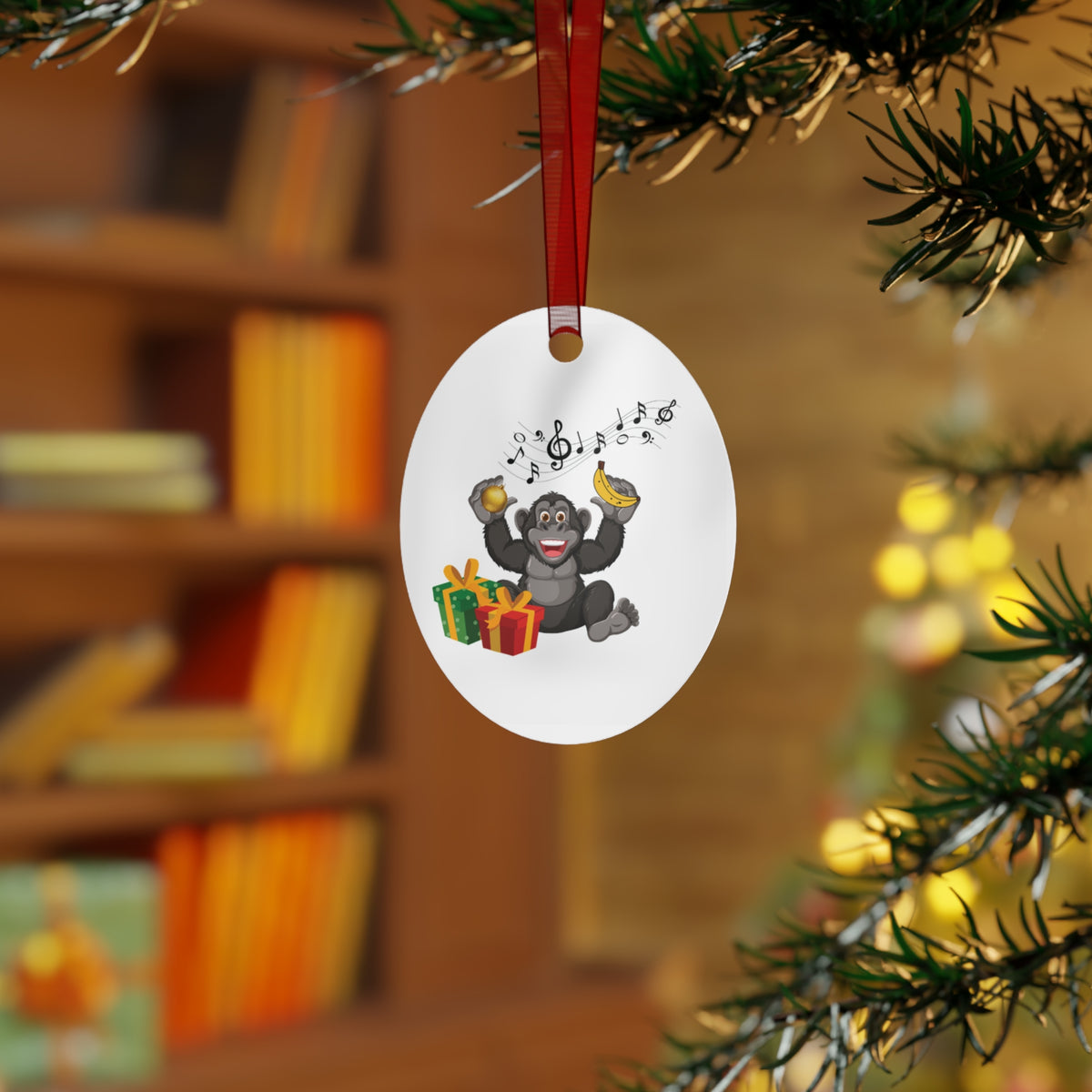 Oval Christmas tree ornament featuring a cheerful gorilla with christmas presents and music notes displayed on a festive pine tree for whimsical holiday decor.