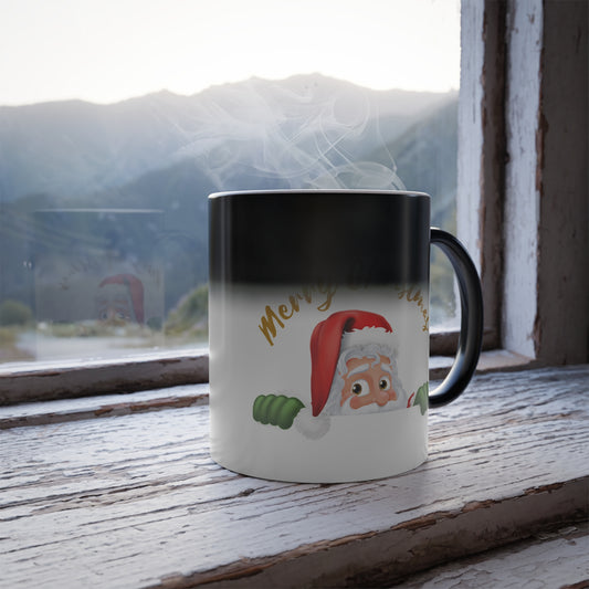 Heat sensitive color changing mug revealing a cute peeking Santa Claus graphic with gold Merry Christmas lettering on a rustic wooden windowsill.   
